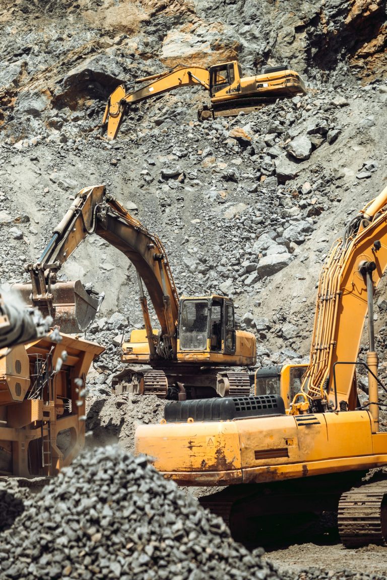 open pit ore mine. Close up details of industrial excavator working on site